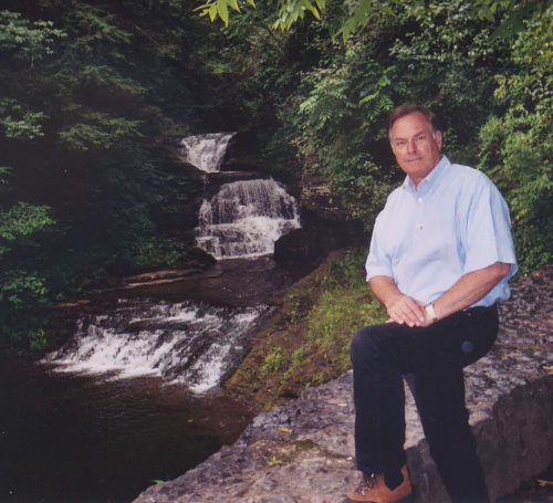 Neil Poppensiek stands by waterfall on Fishkill Creek behind the Old Mill in Robert H. Treman State Park near Ithaca, NY.